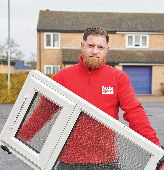 Safestyle installer holding a white uPVC casement window