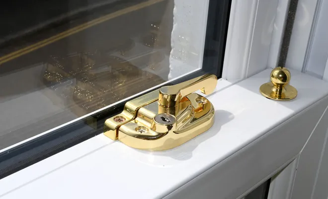 Gold Sash Lock Hardware On Whtie Sash Window Interior
